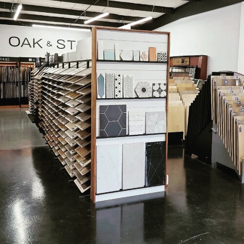 Image presents a the OAK & STONE FLOORS flooring design showroom in Portland Oregon for, displaying Evoke, Kentwood, Provenza, Surface Art, and more, floor covering samples.