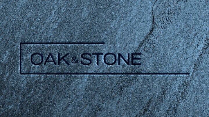 The image presents a rock with OAK & STONE FLOORS etched into it. They say things of importance are written in stone.